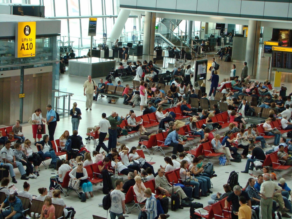 a group of people sitting in chairs in an airport