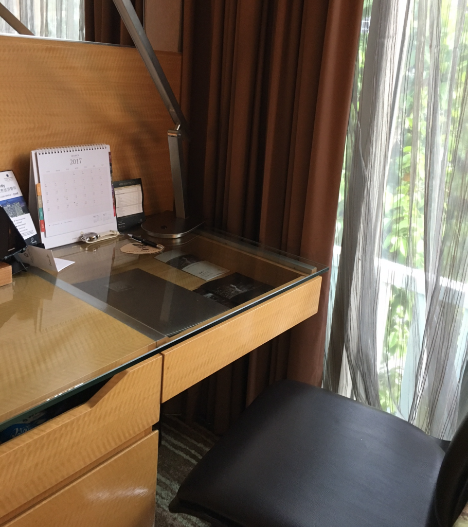 a desk with a desk lamp and a chair