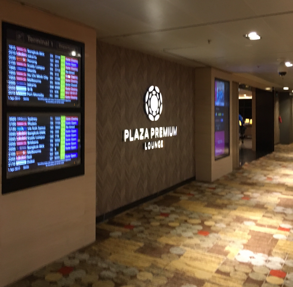 a hallway with a sign and a screen
