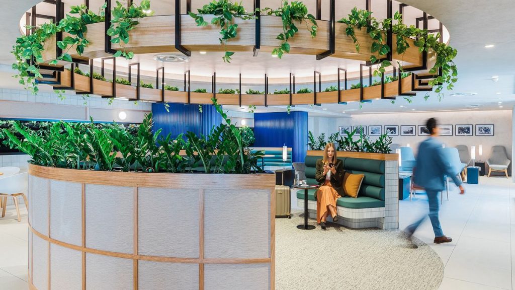 a woman sitting on a couch in a lobby