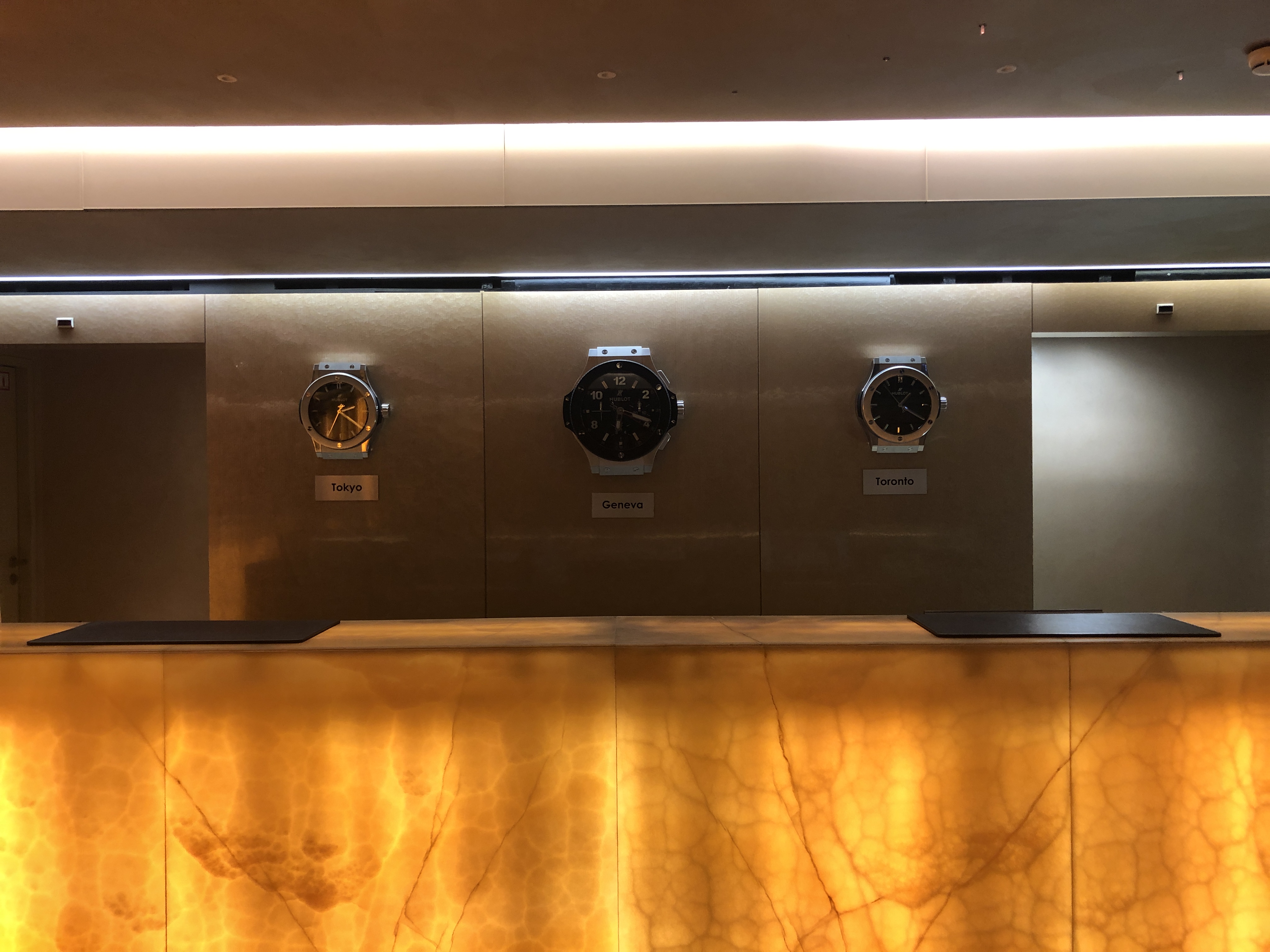 a row of clocks on a wall