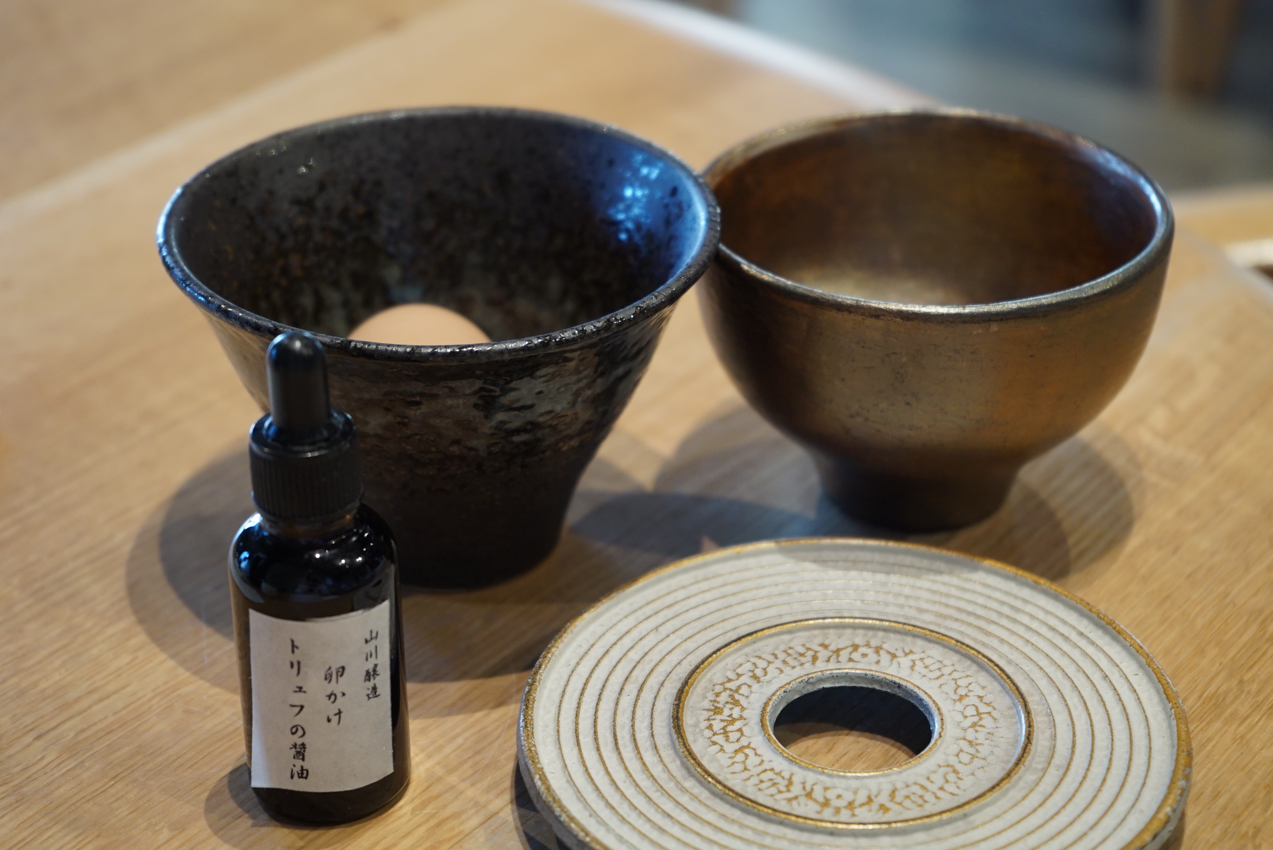 木製のテーブルに置いている数々のカップ
