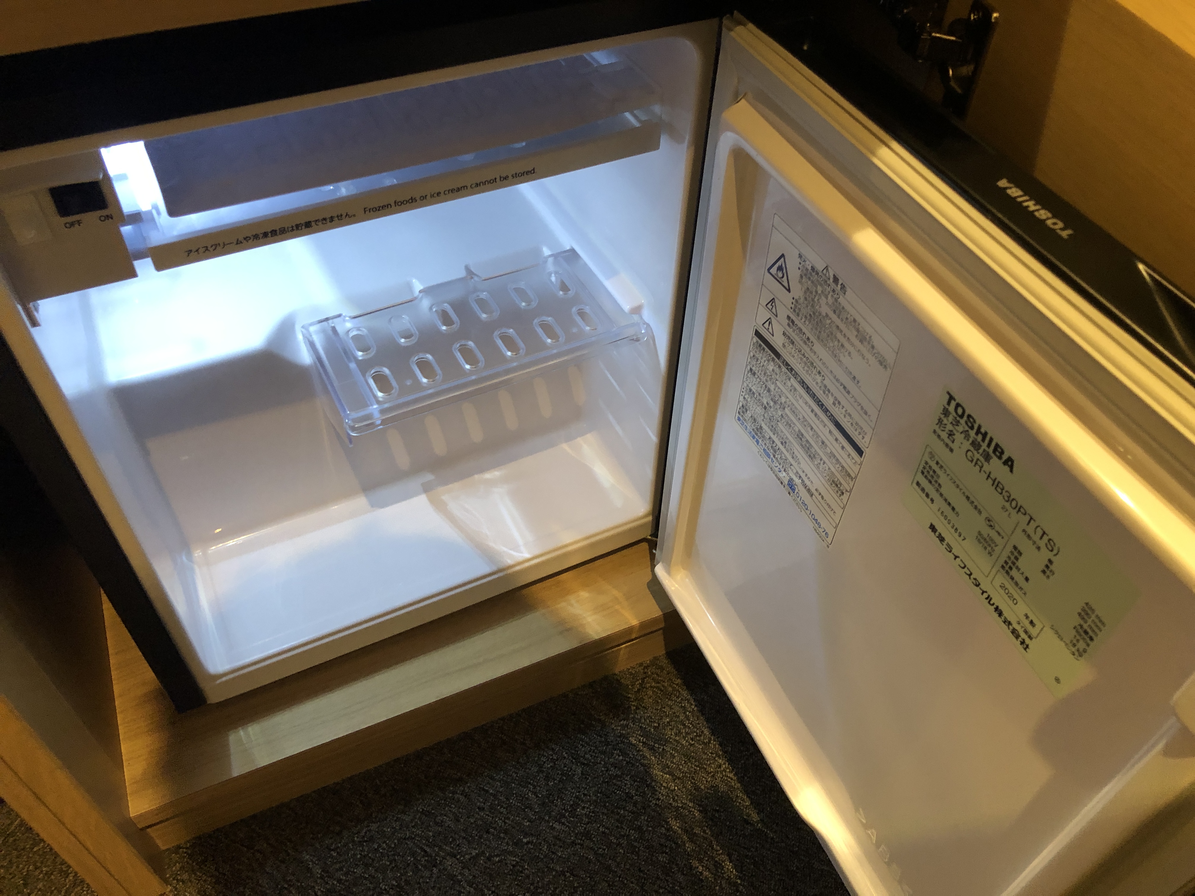 a small refrigerator with a light inside