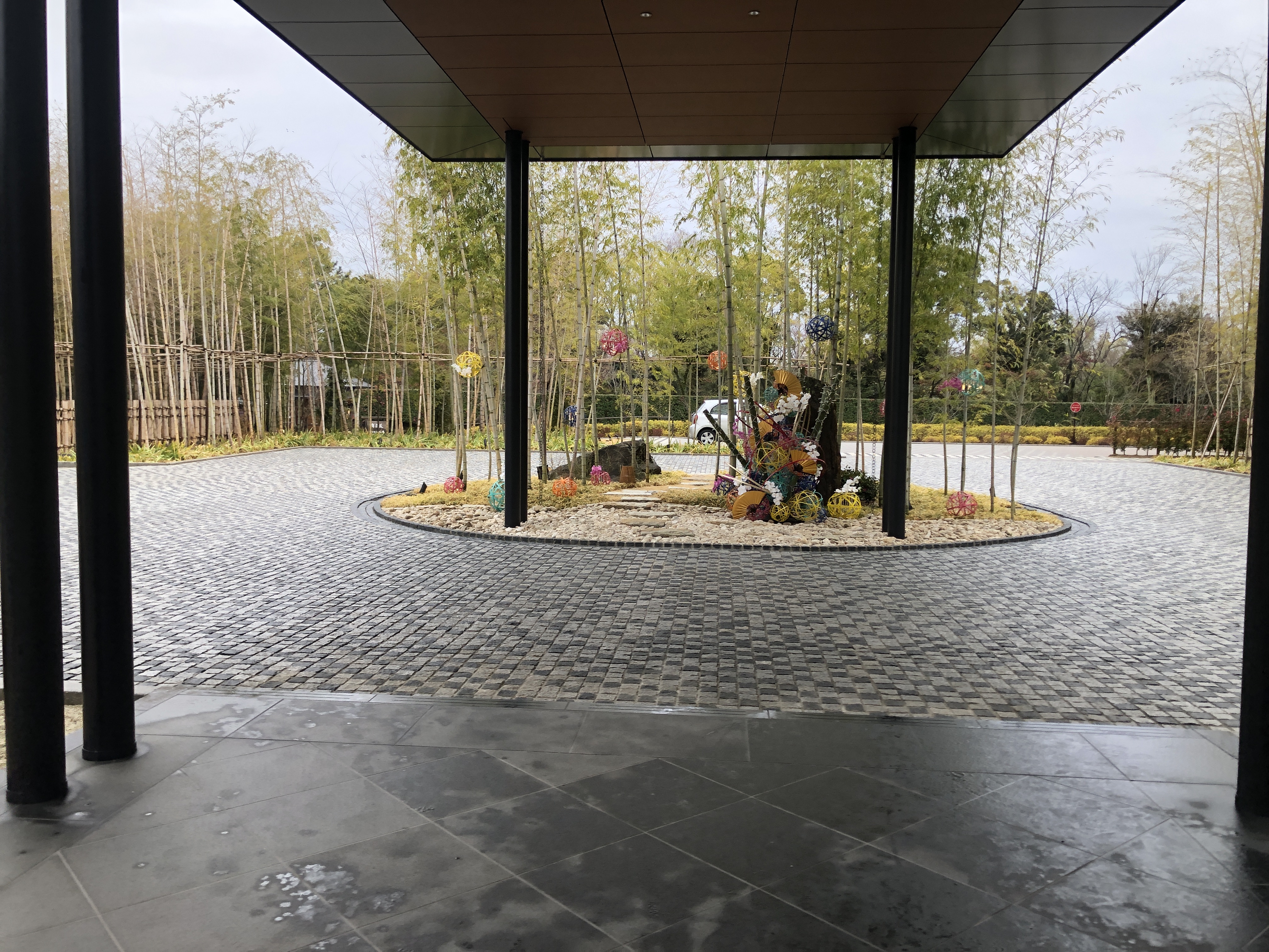 a circular area with trees and a roof