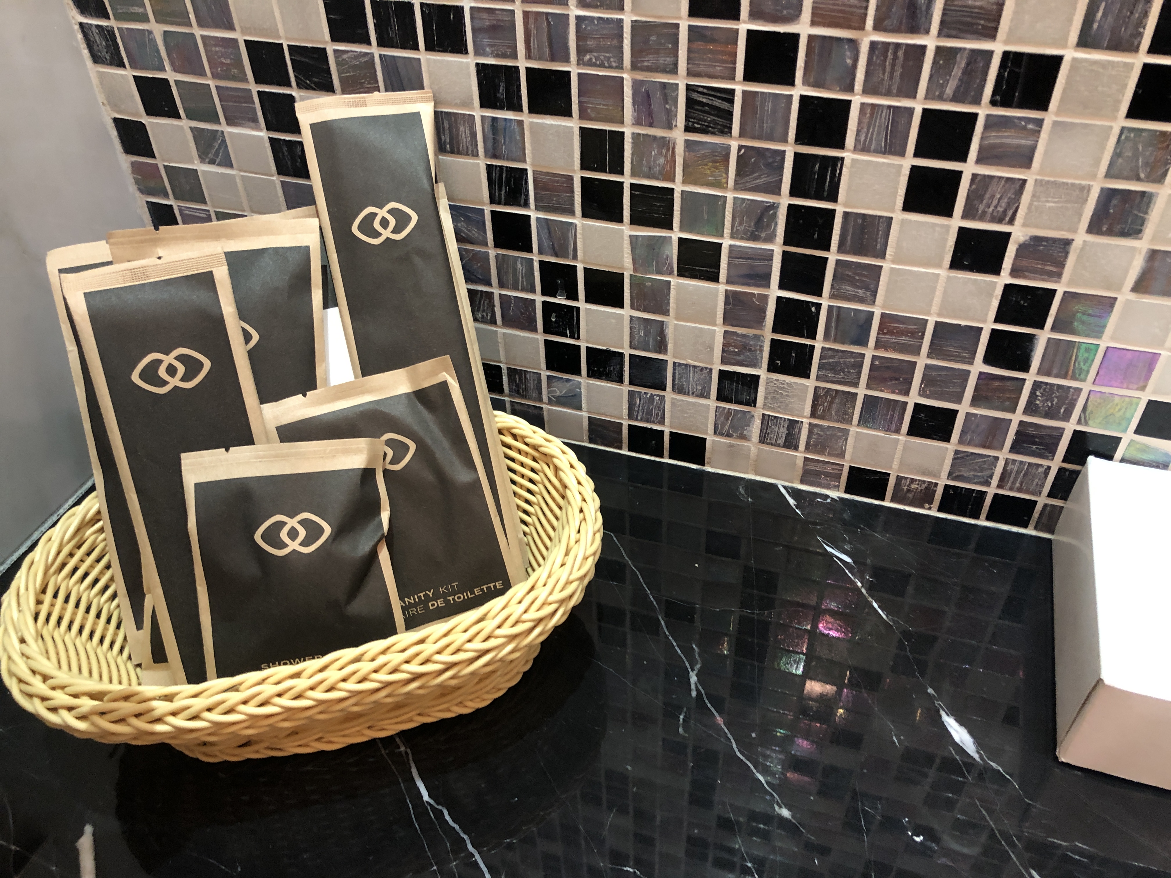 a basket with black and brown bags in it
