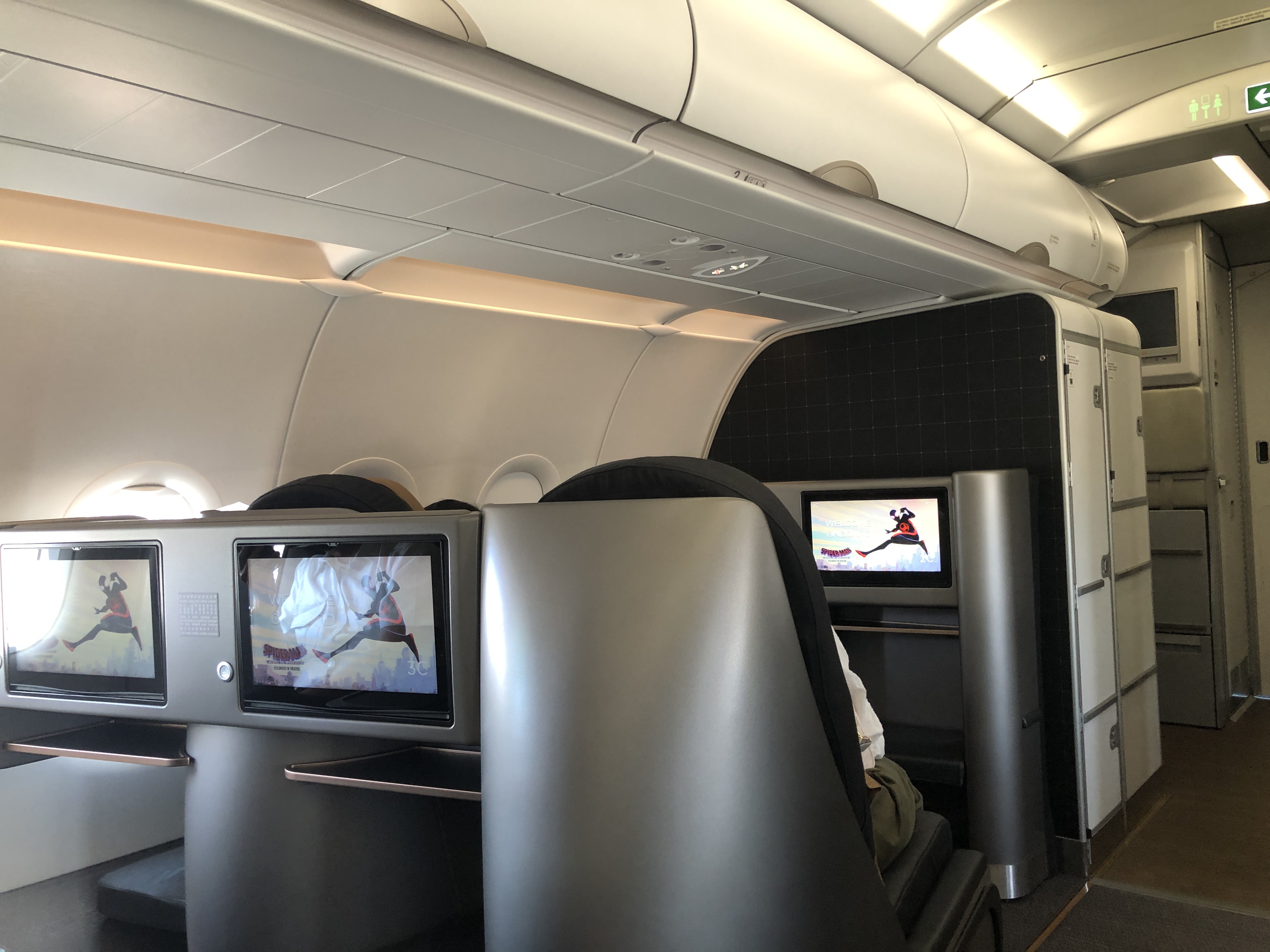 a person sitting in a chair with a television on the back of the seat