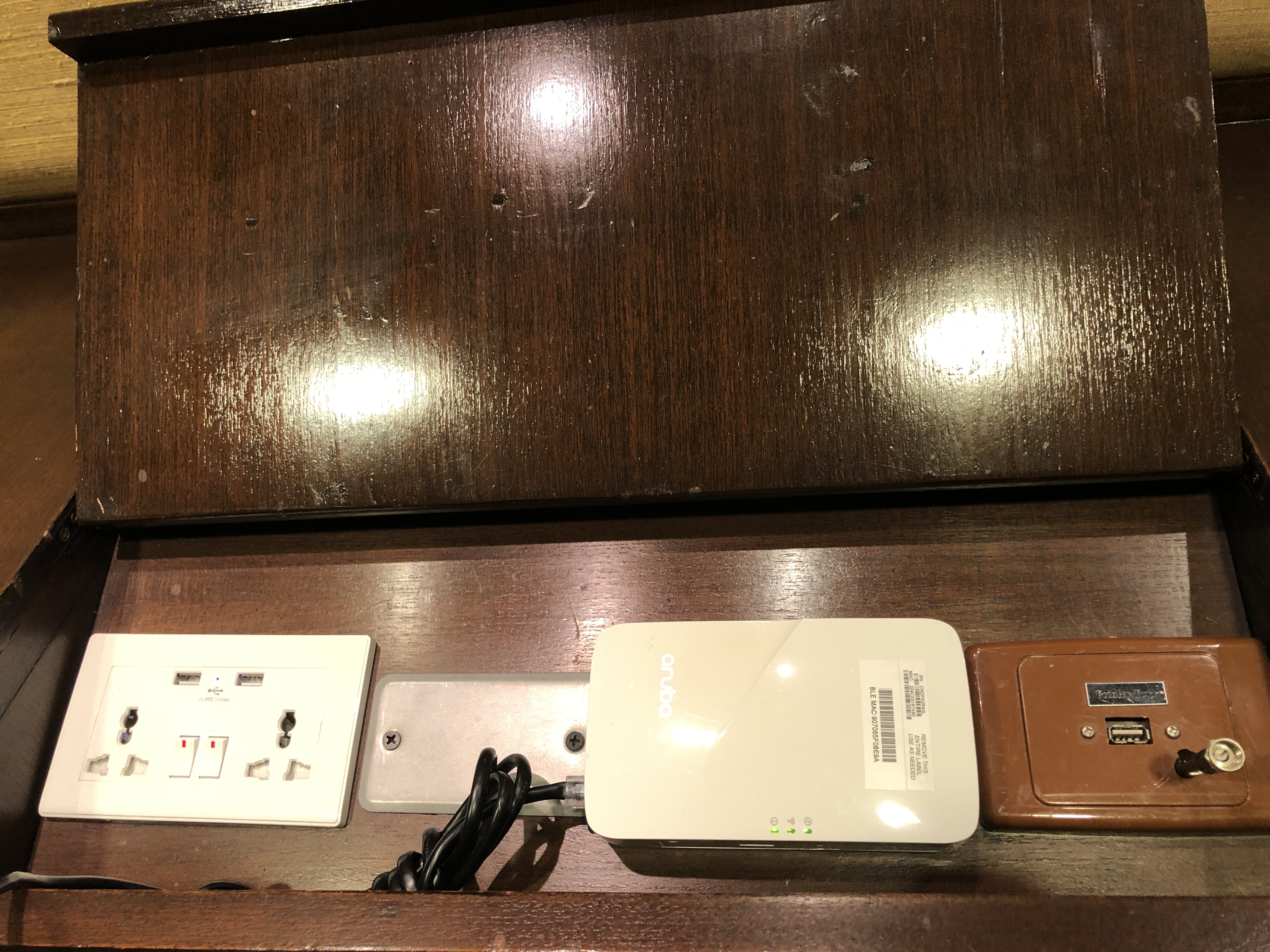a white electrical devices on a wood surface