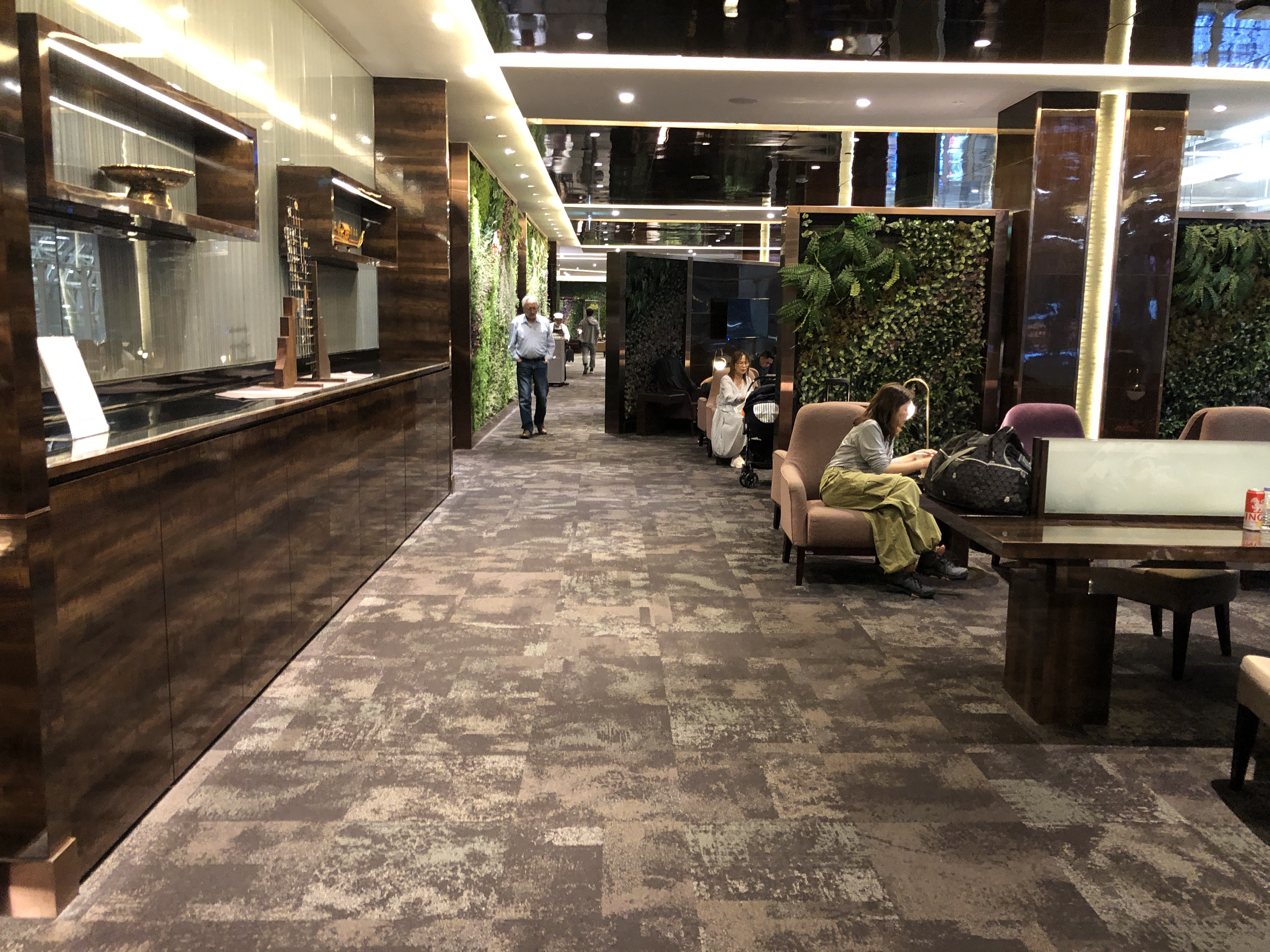 a lobby with a reception desk and people