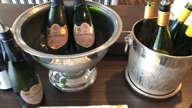 a glass bowl with bottles in it