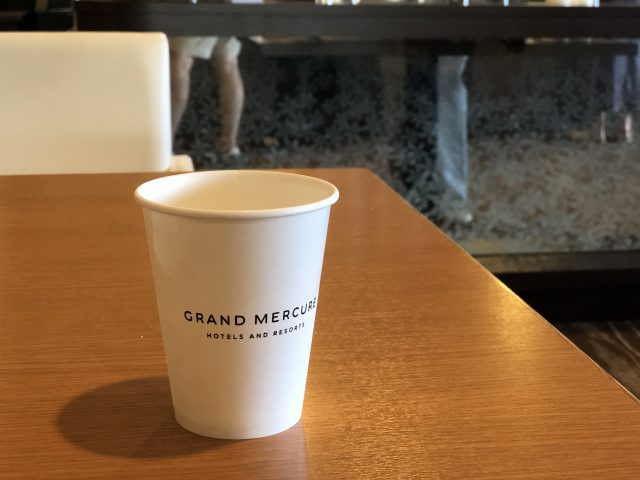 a white coffee cup on a wooden table