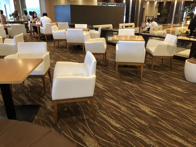 a room with white chairs and tables