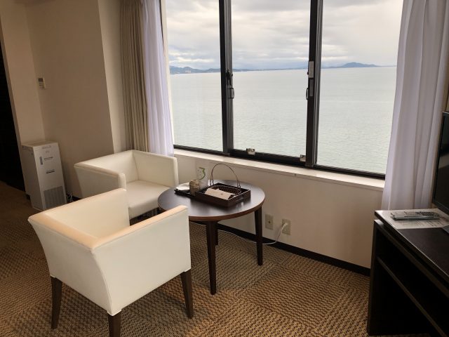 a room with a desk and chairs