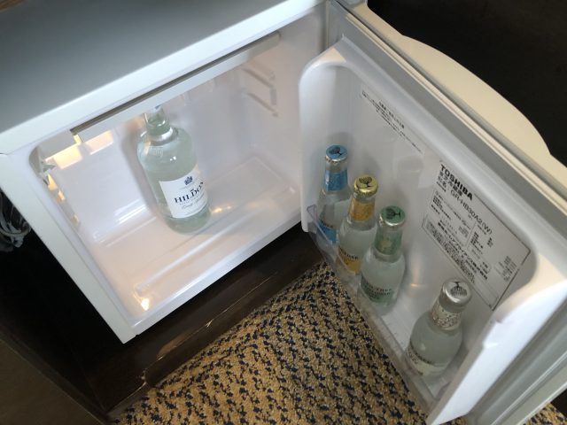 a refrigerator with bottles of liquid