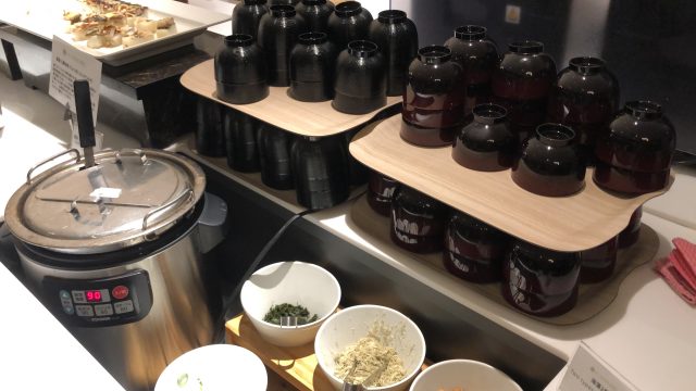 a kitchen counter with many jars of food on it