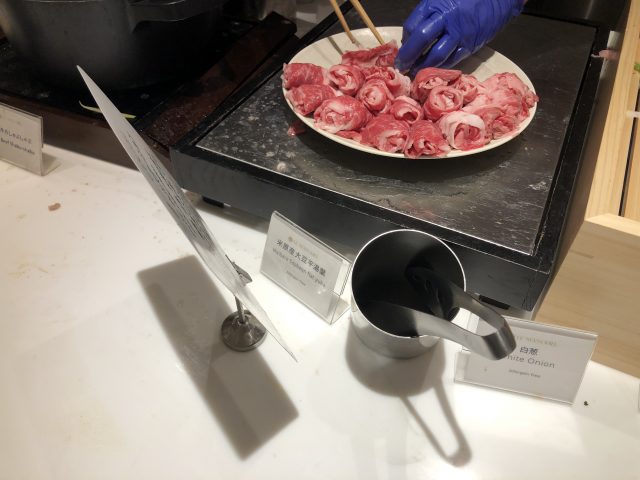 a plate of raw meat on a stove